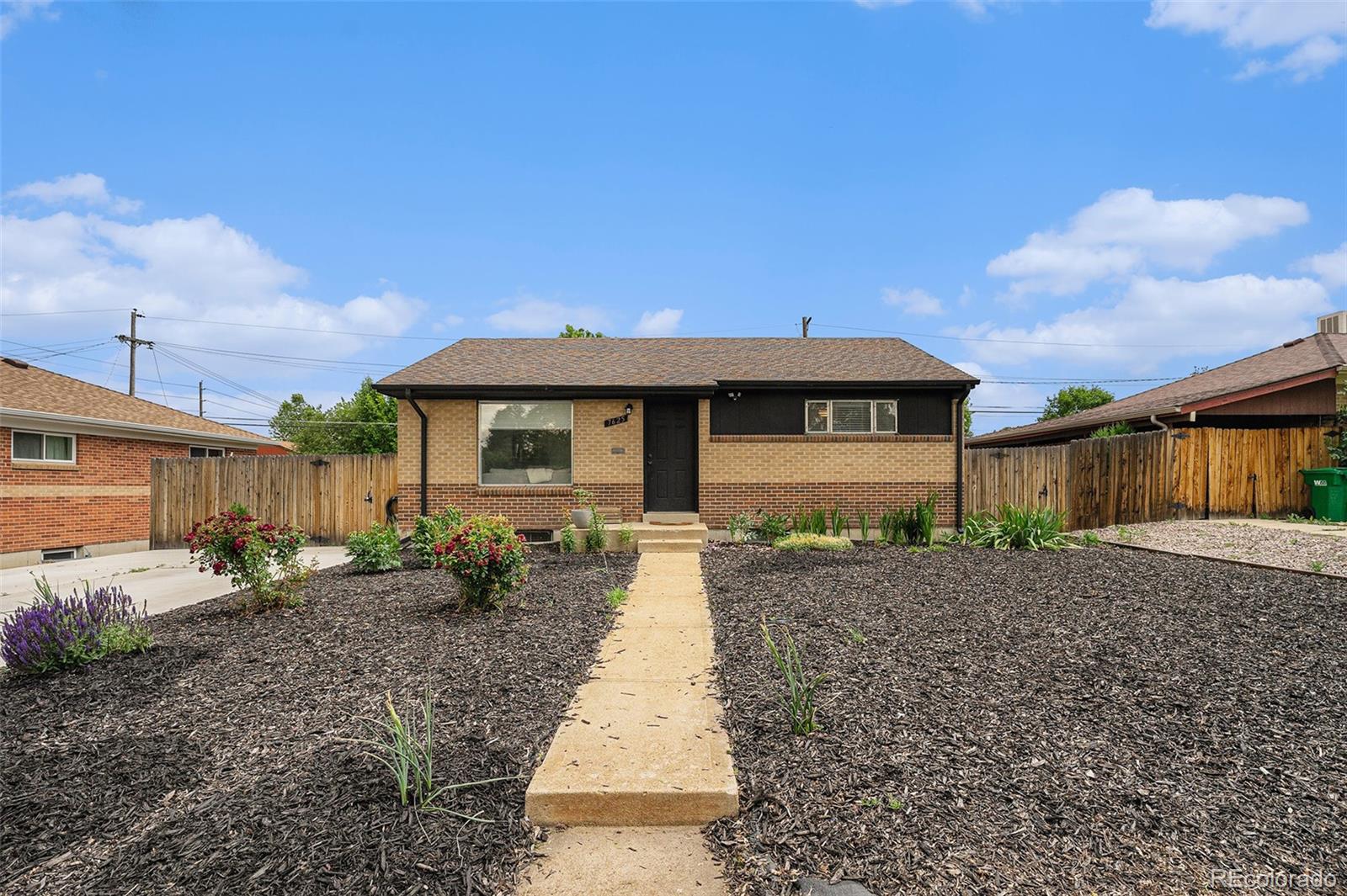 7625 Turner Drive Denver, CO 80221 - Photo 20 of 26 a front view of a house with garden