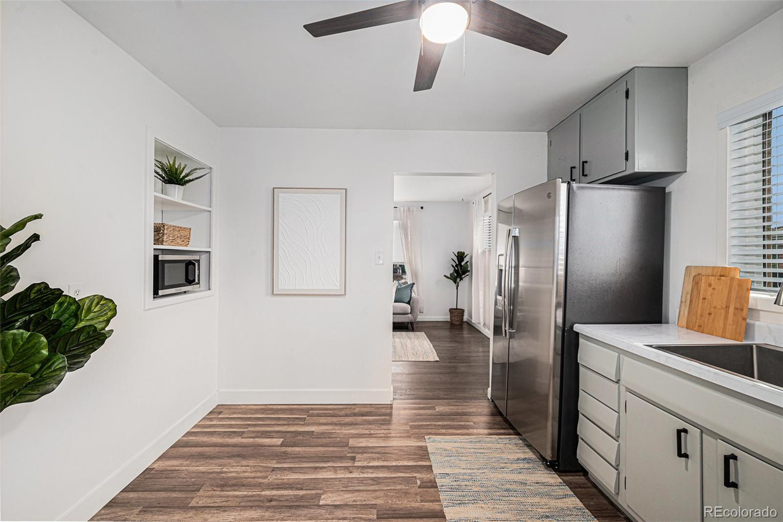 7625 Turner Drive Denver, CO 80221 - Photo 3 of 26 a kitchen with stainless steel appliances a refrigerator and a chandelier