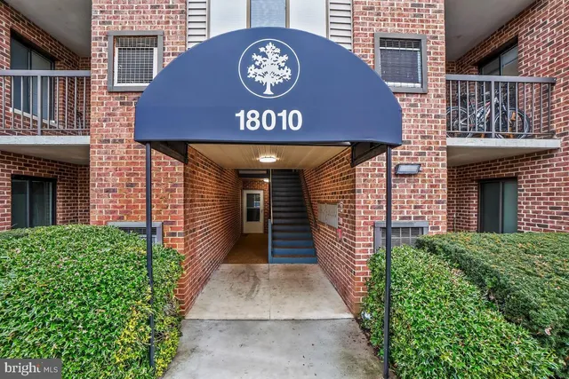 a sign board with a small yard and wooden fence