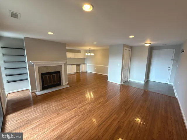 a view of a room with wooden floors and fireplace