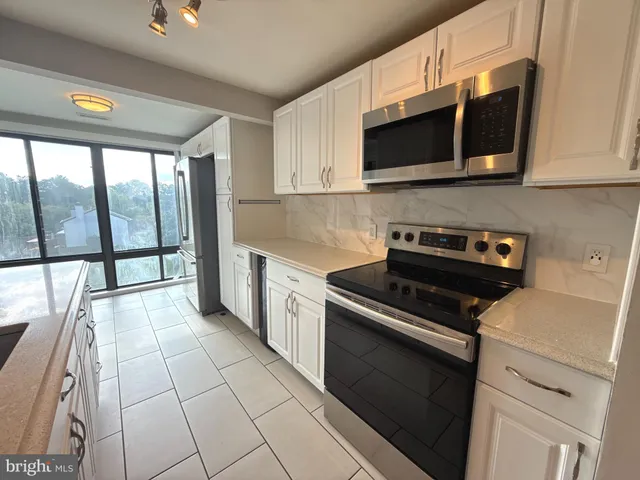 a kitchen with a stove and a microwave