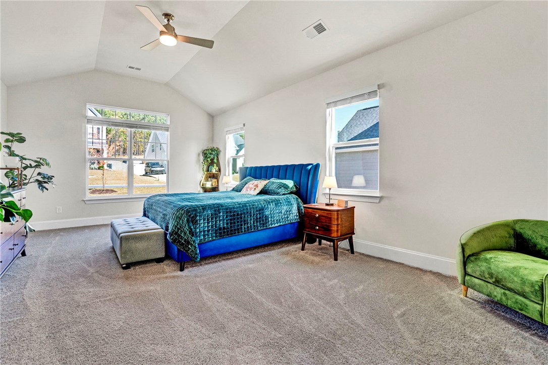 142 Juniper Hill Drive Easley, SC 29642 - Photo 23 of 47 Bright and airy primary bedroom with vaulted ceilings and large windows.
