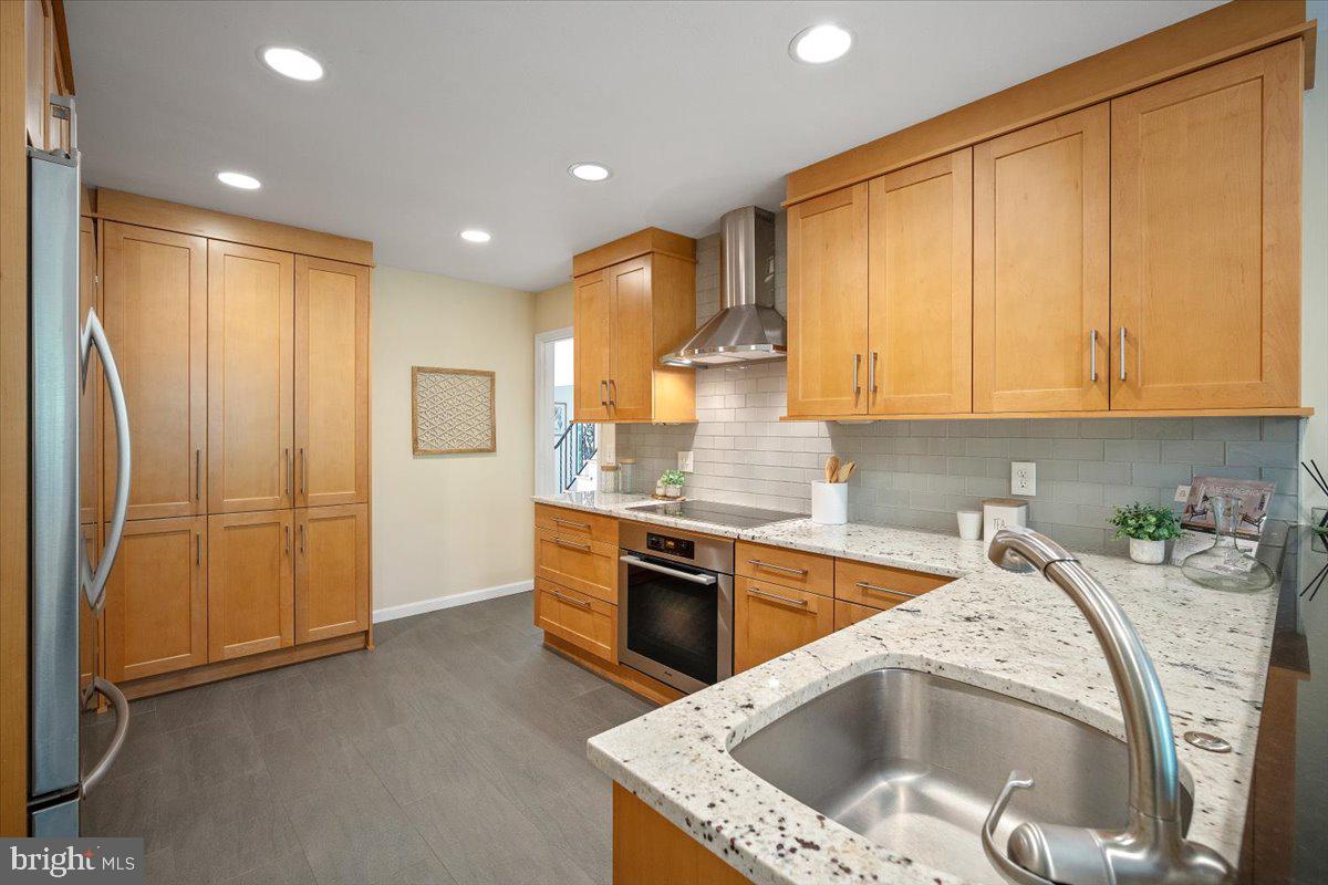 6305 Lenox Road Bethesda, MD 20817 - Photo 13 of 49 a kitchen with stainless steel appliances granite countertop a sink a refrigerator and a stove top oven