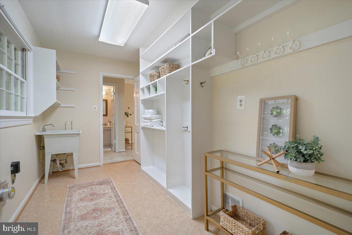 6305 Lenox Road Bethesda, MD 20817 - Photo 20 of 49 a hallway with a potted plant on a counter and a sink