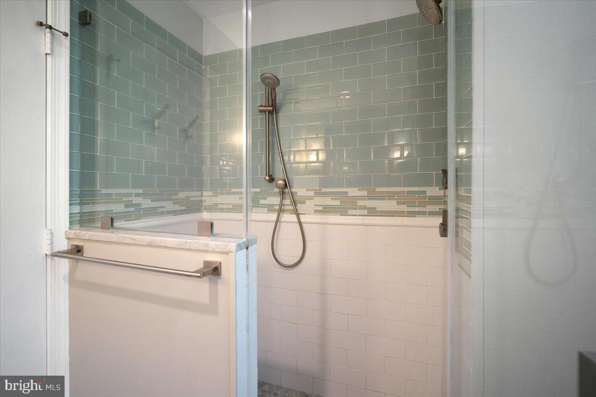 6305 Lenox Road Bethesda, MD 20817 - Photo 31 of 49 a bathroom with a granite countertop shower mirror and toilet