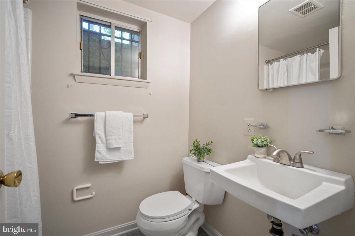 6305 Lenox Road Bethesda, MD 20817 - Photo 39 of 49 a white toilet sitting next to a bathroom sink