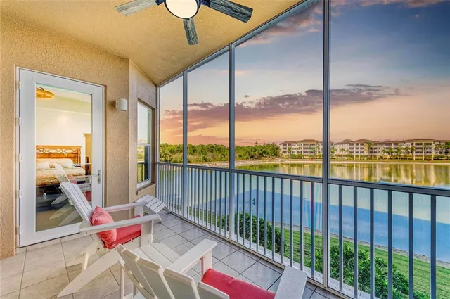 a living room with furniture and a floor to ceiling window