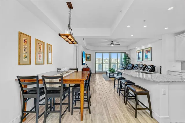 a bedroom with a bed a mirror on dresser and a chandelier