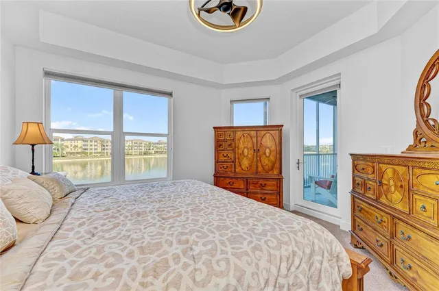 a bathroom with a granite countertop double vanity sink and mirror