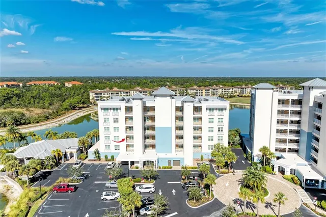 a view of a hallway with wooden floor and a bathroom
