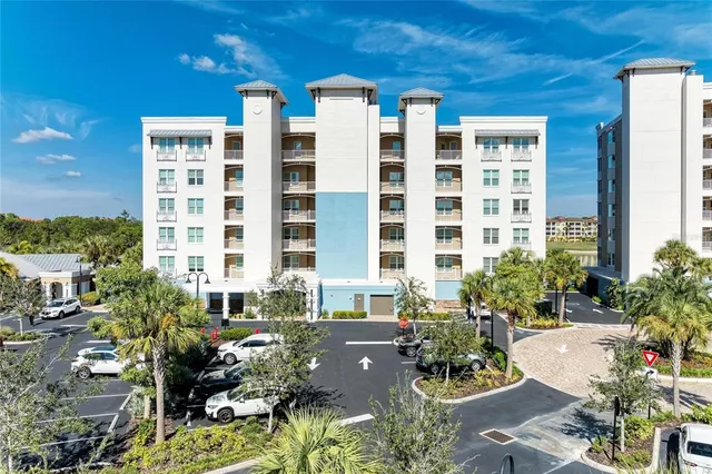 a view of a hallway with wooden floor and a living room