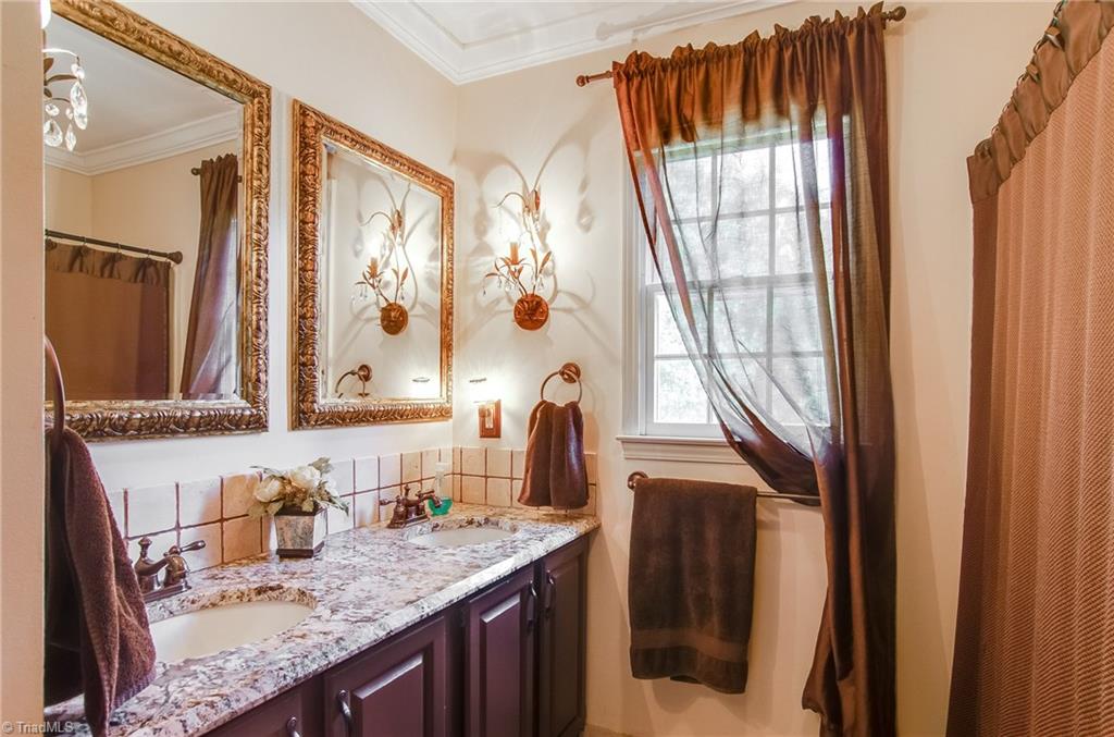 7607 Strawberry Road Summerfield, NC 27358 - Photo 23 of 30 Hall bath has been beautifully updated. Sorry the 2 sconces are moving with the owners.