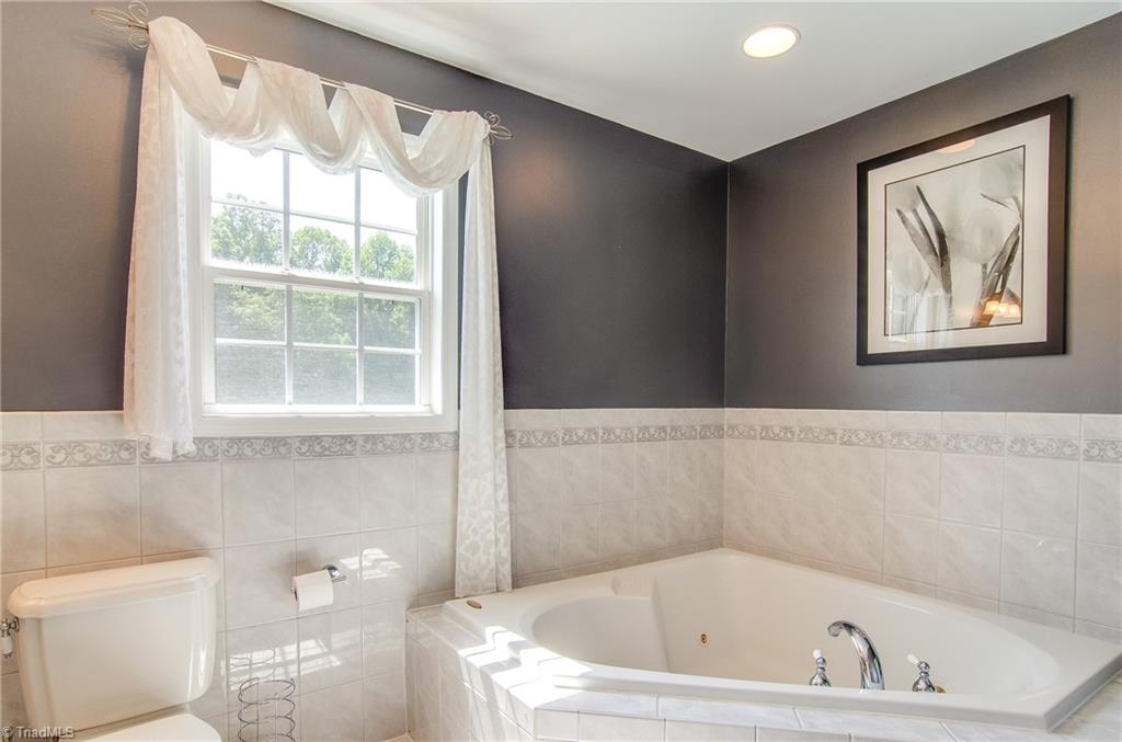 7607 Strawberry Road Summerfield, NC 27358 - Photo 28 of 30 Lavish bath room with Jacuzzi tub, perfect for relaxing.