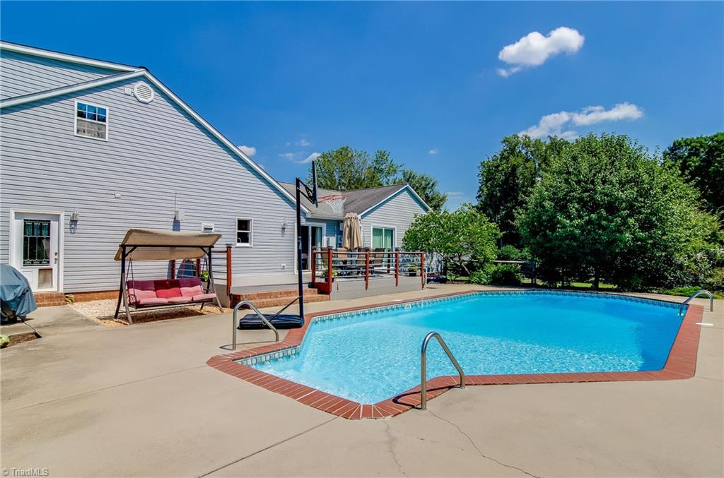 7607 Strawberry Road Summerfield, NC 27358 - Photo 6 of 30 Great private outdoor entertaining area. Enjoying swimming in the salt water pool on these hot days!