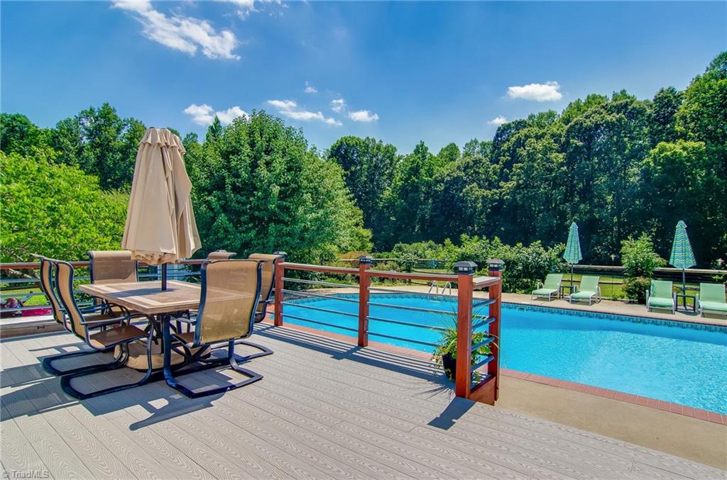 7607 Strawberry Road Summerfield, NC 27358 - Photo 9 of 30 Deck has composite flooring. Enjoy views of your beautiful and very secluded back yard!