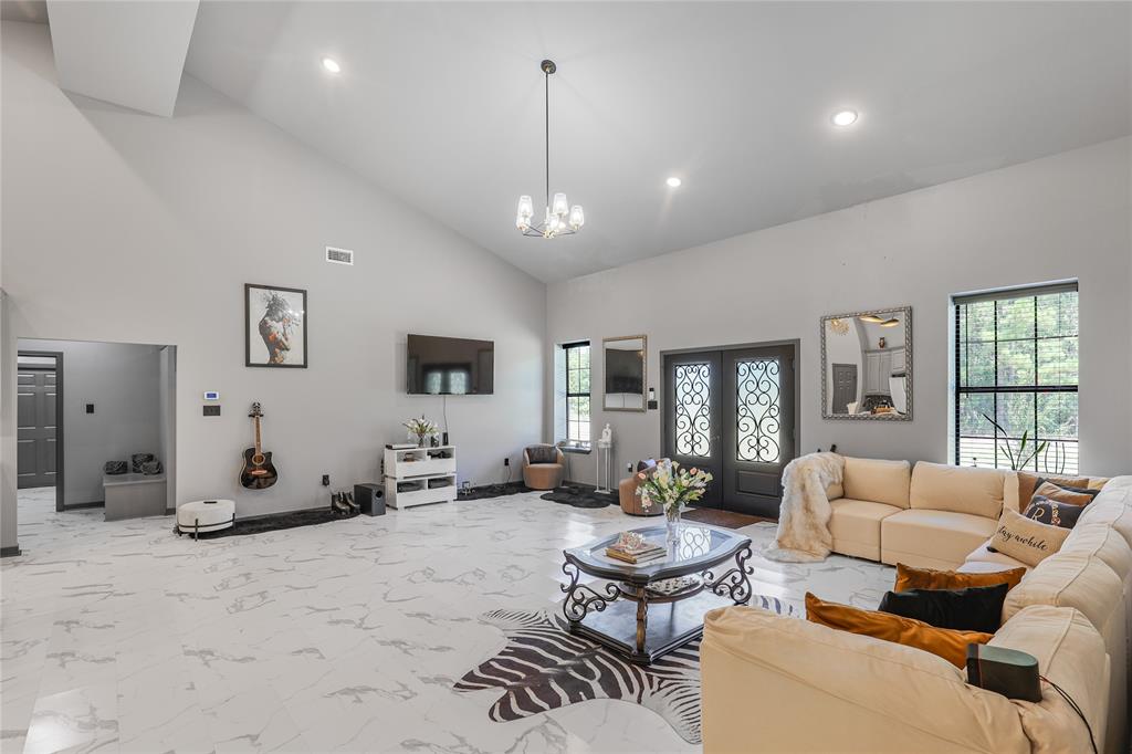 1373 George Ephram Cord 166 Road Overton, TX 75684 - Photo 6 of 40 Vaulted ceilings, recessed lighting, double entry doors with decorative ironwork, large windows, and large-format floor tiling
