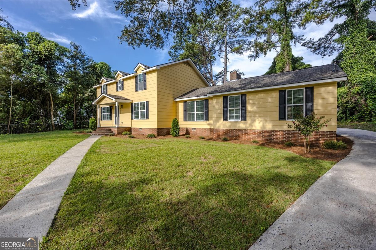 1339 Grant Street Perry, GA 31069 - Photo 1 of 1 a front view of house with yard and green space