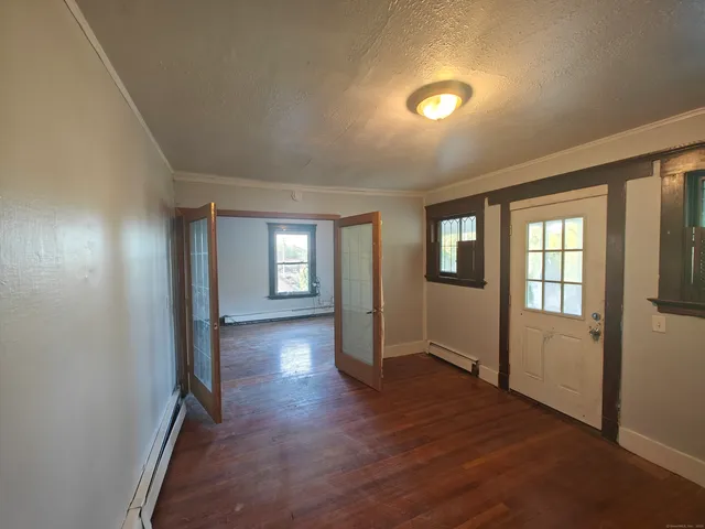 wooden floor in an empty room with a window