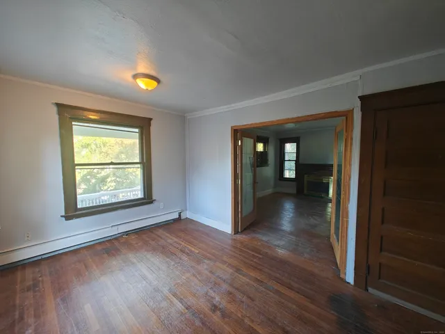 wooden floor in an empty room with a window