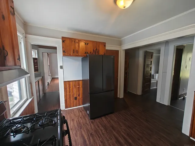 a kitchen with stainless steel appliances granite countertop a refrigerator and a stove