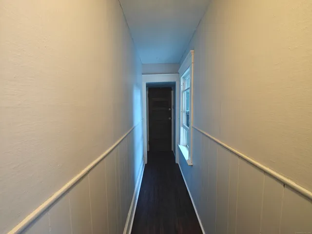a view of a hallway with wooden floor