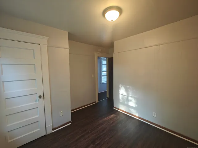 an empty room with wooden floor