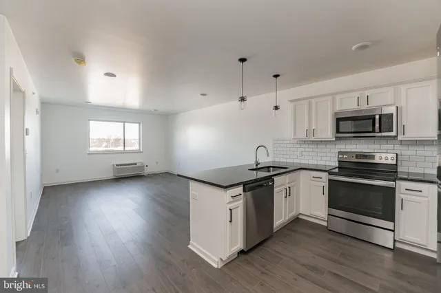 a kitchen with granite countertop a stove and a sink