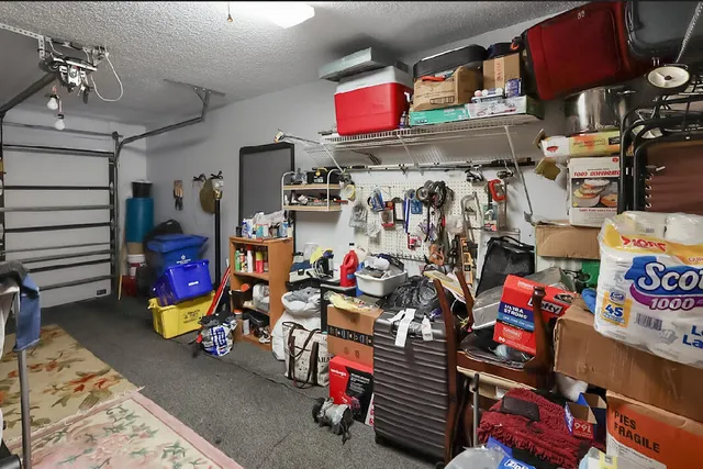 a front view of a house with a garden and trees