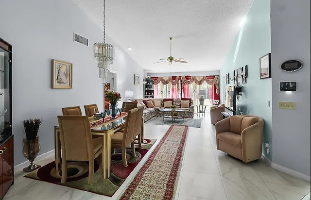 a living room with furniture a rug and white walls