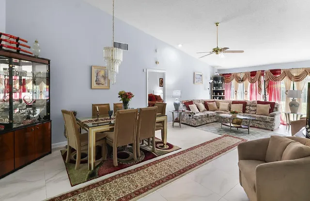 a open kitchen with stainless steel appliances granite countertop a sink dishwasher a refrigerator and cabinets with wooden floor