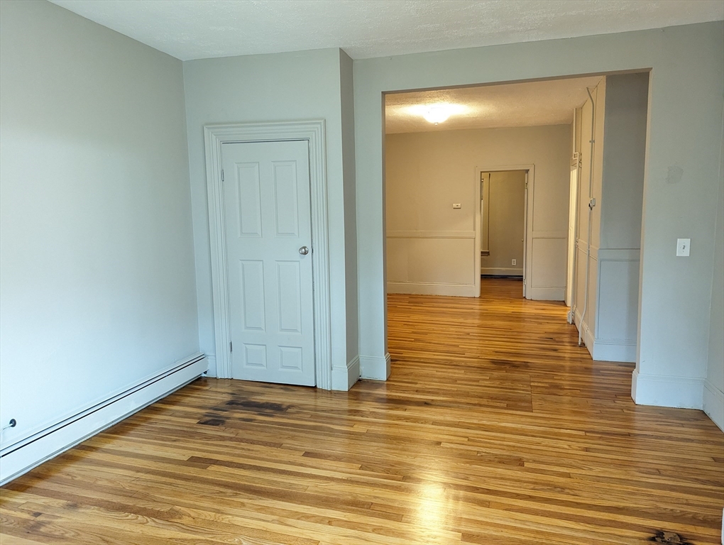 219 Green Street, Unit 2 Cambridge, MA 02139 - Photo 2 of 7 a view of a room with wooden floor