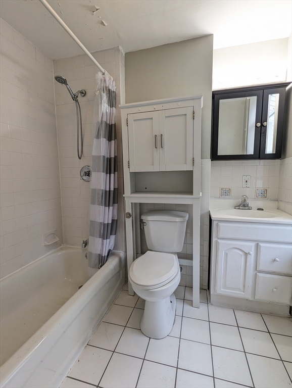 219 Green Street, Unit 2 Cambridge, MA 02139 - Photo 6 of 7 a bathroom with a toilet sink and mirror