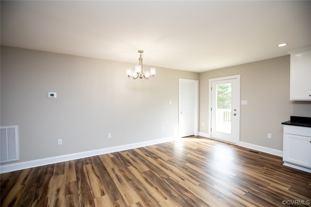 4086 Pin Oak Road Prospect, VA 23960 - Photo 14 of 44 a view of empty room with wooden floor and fan