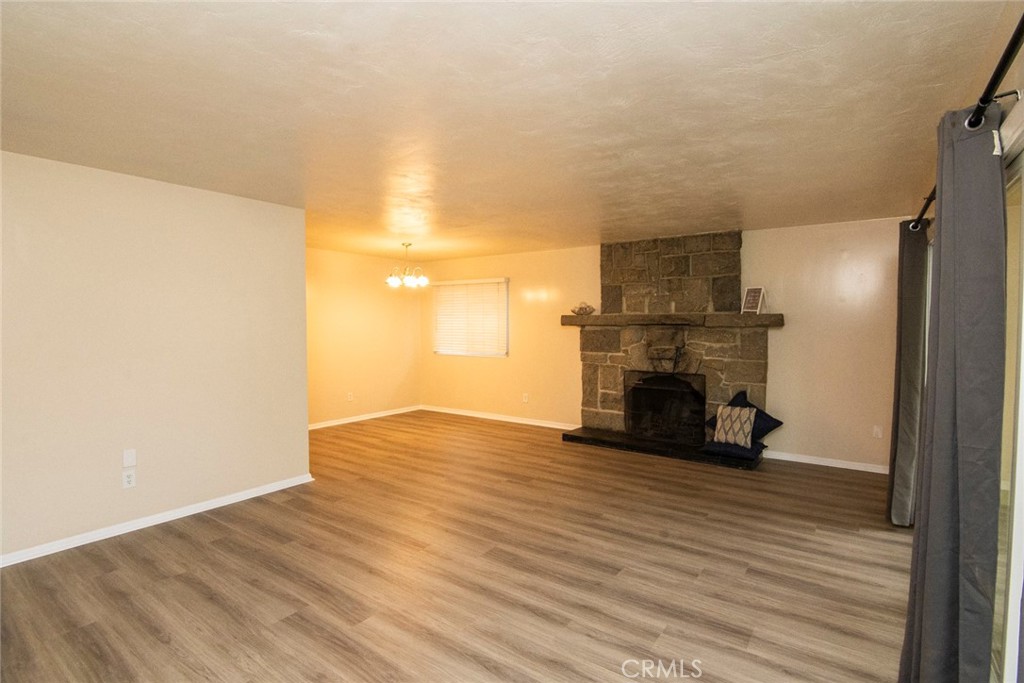 2983 Cheyenne Road Riverside, CA 92506 - Photo 13 of 49 a view of a room with wooden floor and a fireplace
