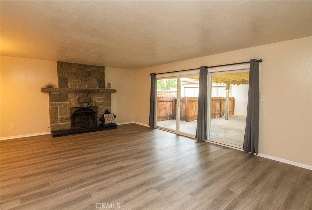 2983 Cheyenne Road Riverside, CA 92506 - Photo 14 of 49 a view of empty room with wooden floor and fireplace