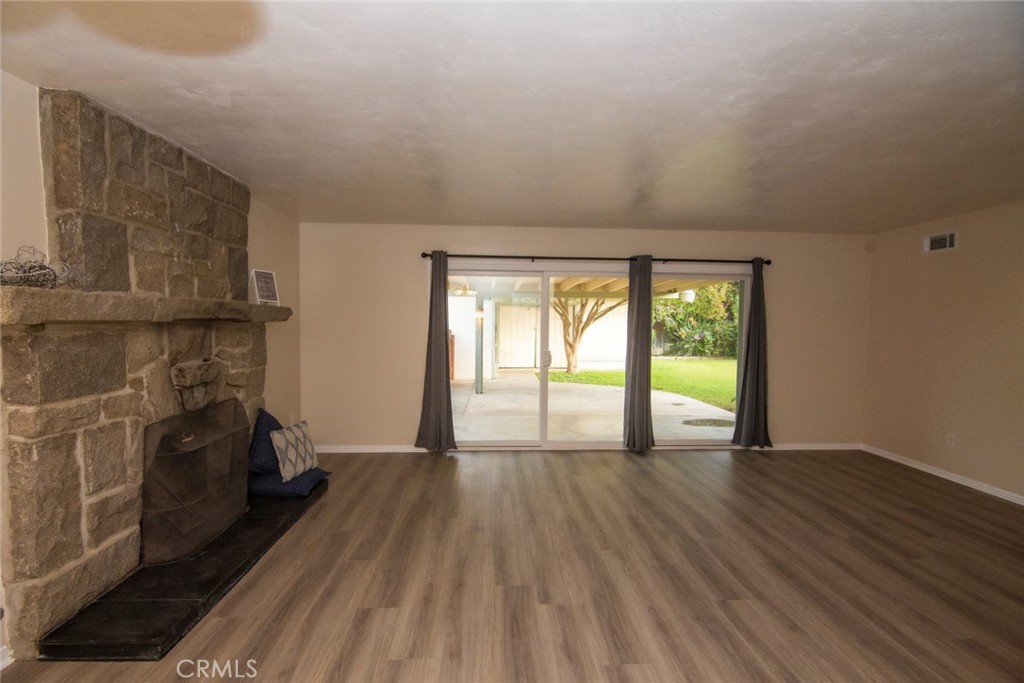 2983 Cheyenne Road Riverside, CA 92506 - Photo 16 of 49 a view of empty room with wooden floor and fireplace