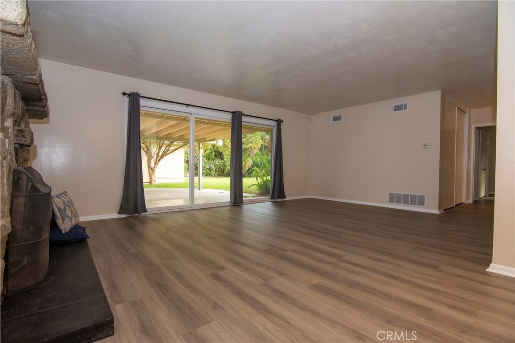 2983 Cheyenne Road Riverside, CA 92506 - Photo 17 of 49 an empty room with wooden floor and windows