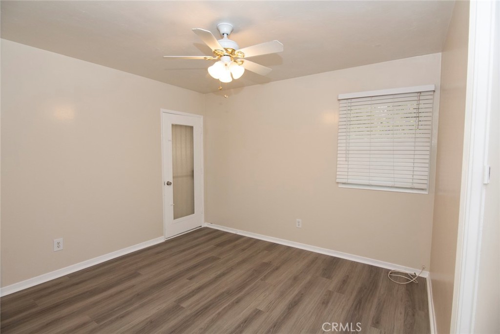 2983 Cheyenne Road Riverside, CA 92506 - Photo 21 of 49 a view of an empty room with wooden floor and a window