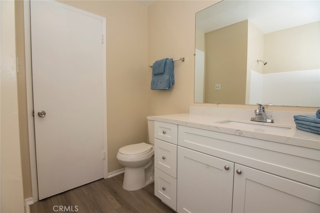 2983 Cheyenne Road Riverside, CA 92506 - Photo 23 of 49 a bathroom with a toilet a sink and mirror