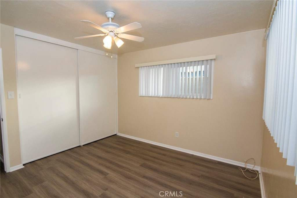 2983 Cheyenne Road Riverside, CA 92506 - Photo 27 of 49 a view of an empty room with wooden floor and a ceiling fan