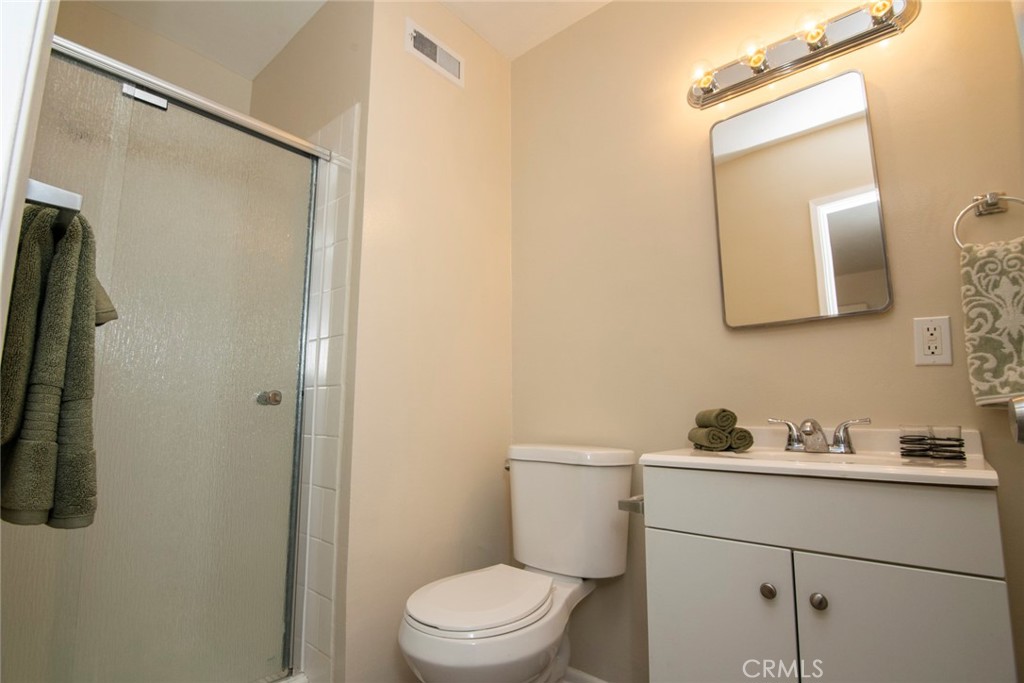 2983 Cheyenne Road Riverside, CA 92506 - Photo 33 of 49 a bathroom with a toilet sink vanity and mirror