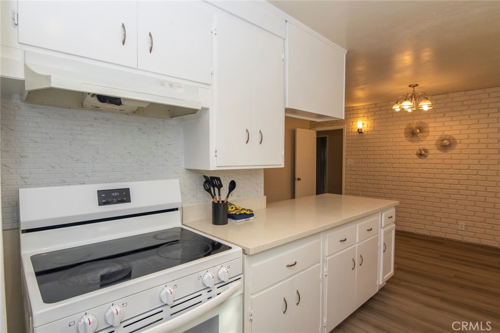 2983 Cheyenne Road Riverside, CA 92506 - Photo 43 of 49 a kitchen with cabinets appliances and a wooden floor