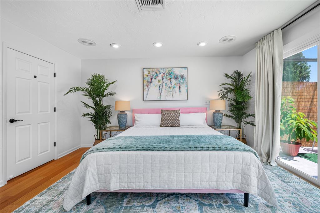 2153 Karan Way Clearwater, FL 33763 - Photo 31 of 65 a bedroom with a large bed and a potted plant