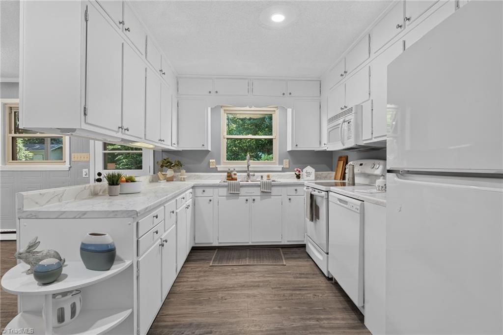 113 Green Valley Road Greensboro, NC 27403 - Photo 15 of 46 With generous counter space and abundant cabinetry, this kitchen is ready for everything from busy mornings to holiday baking.