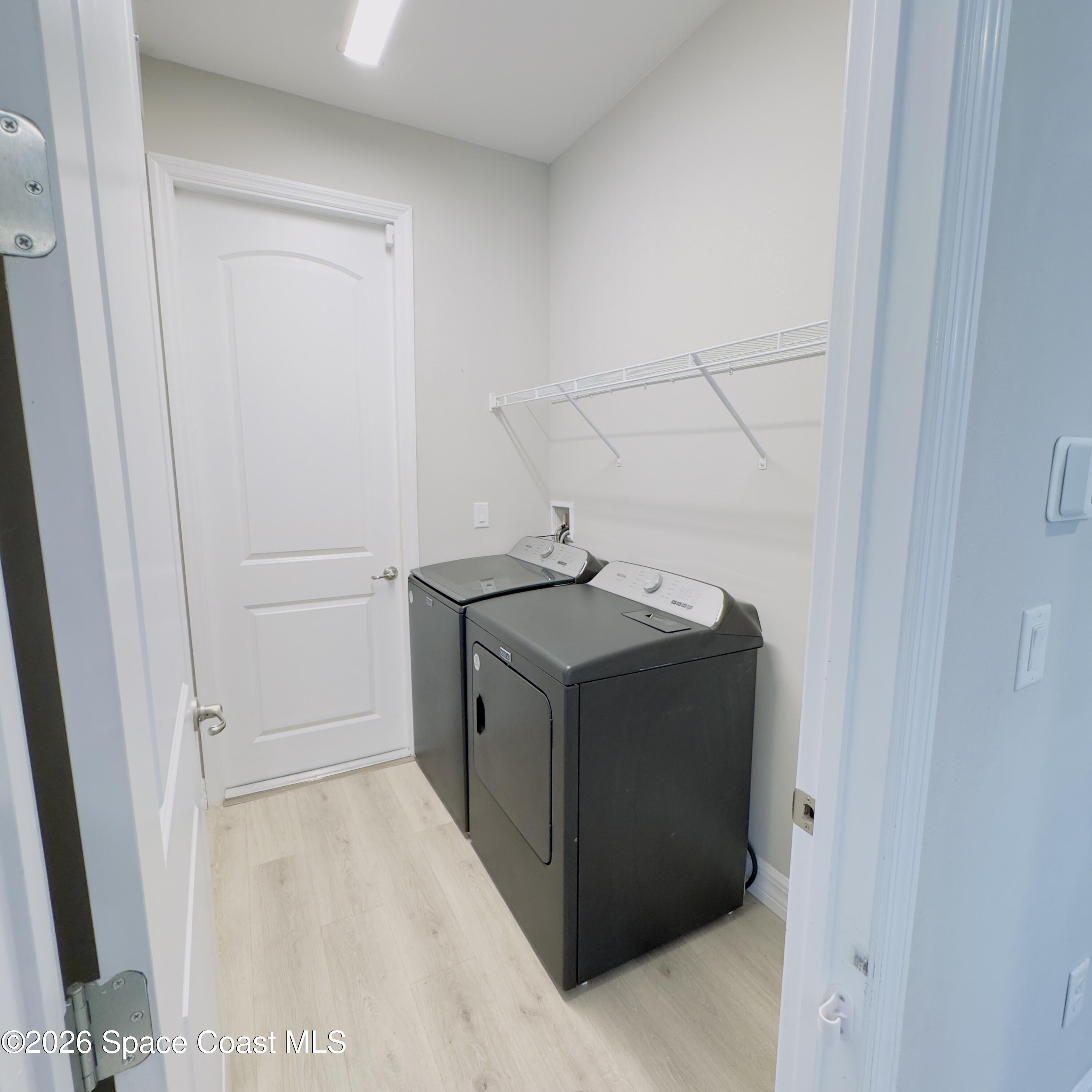 1376 Torgerson Road Southeast Palm Bay, FL 32909 - Photo 12 of 15 a utility room with cabinets washer and dryer