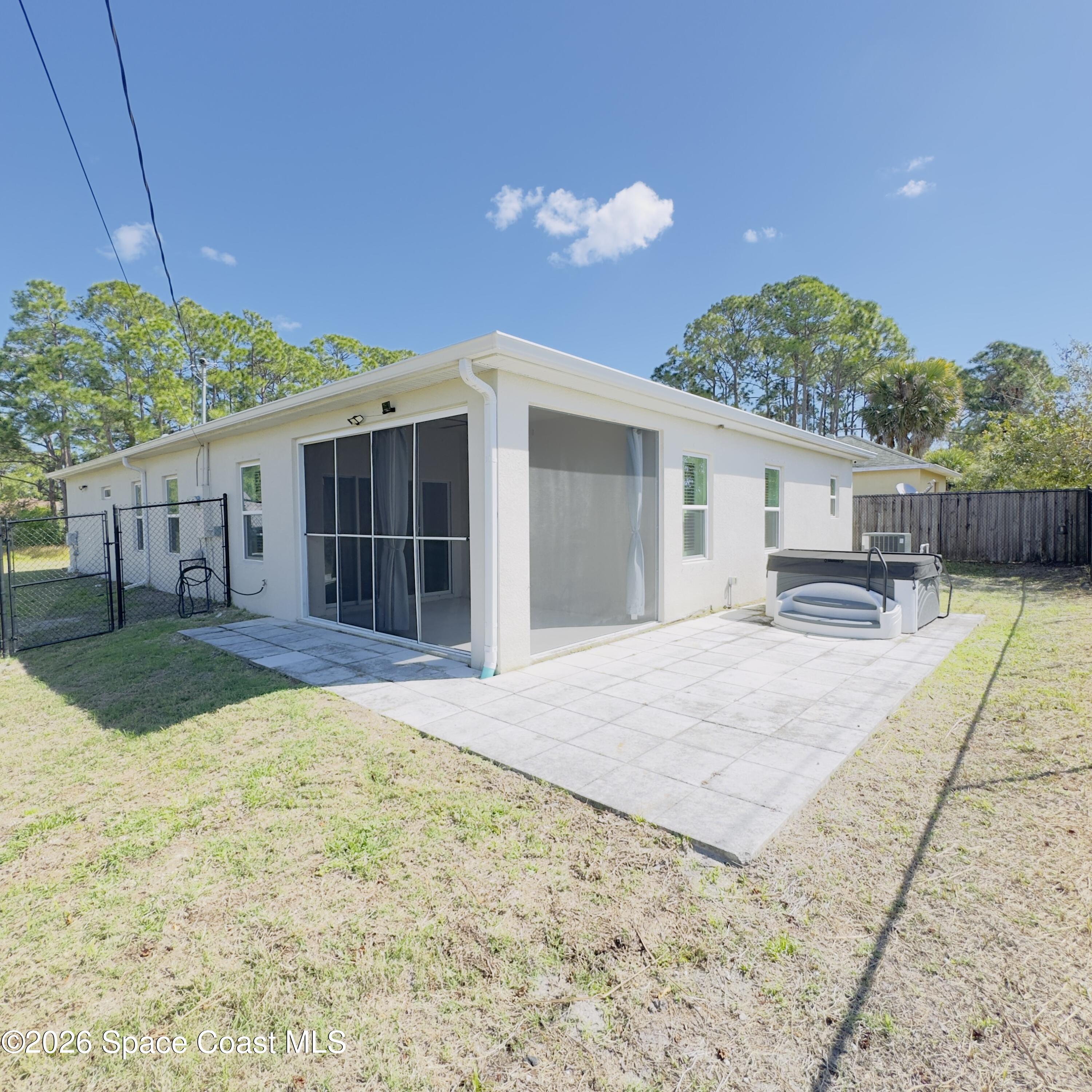 1376 Torgerson Road Southeast Palm Bay, FL 32909 - Photo 13 of 15 a front view of a house with a yard and potted plants