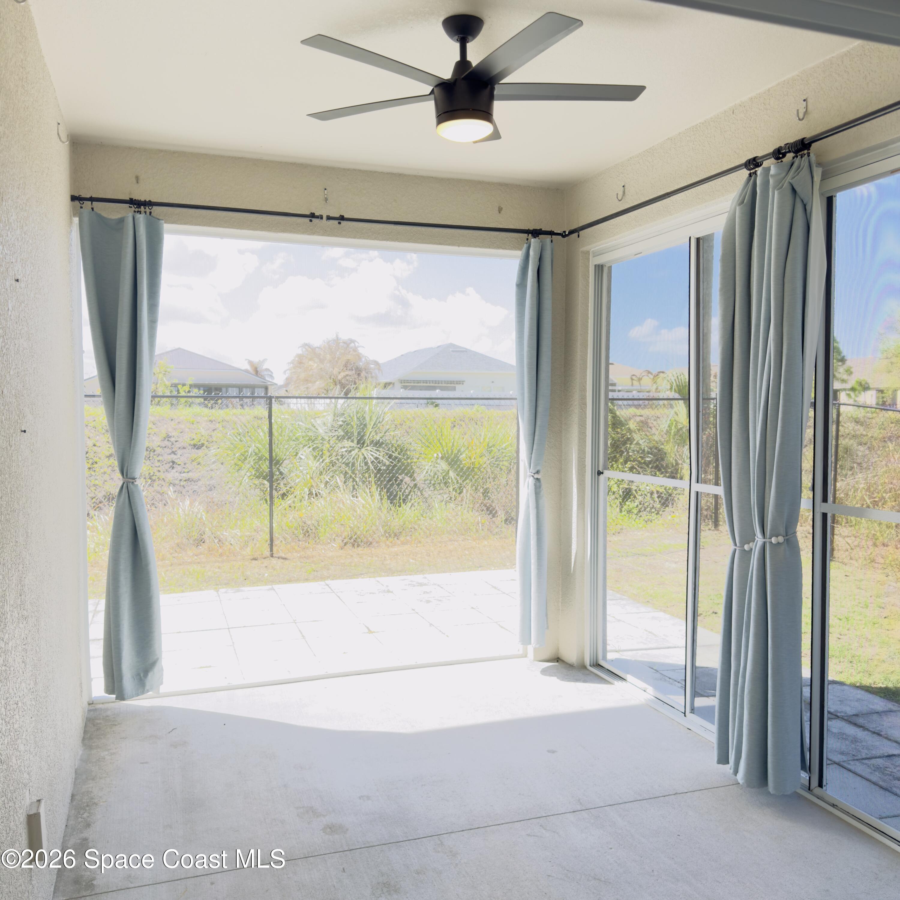 1376 Torgerson Road Southeast Palm Bay, FL 32909 - Photo 14 of 15 a view of hallway with a large window and a ceiling fan