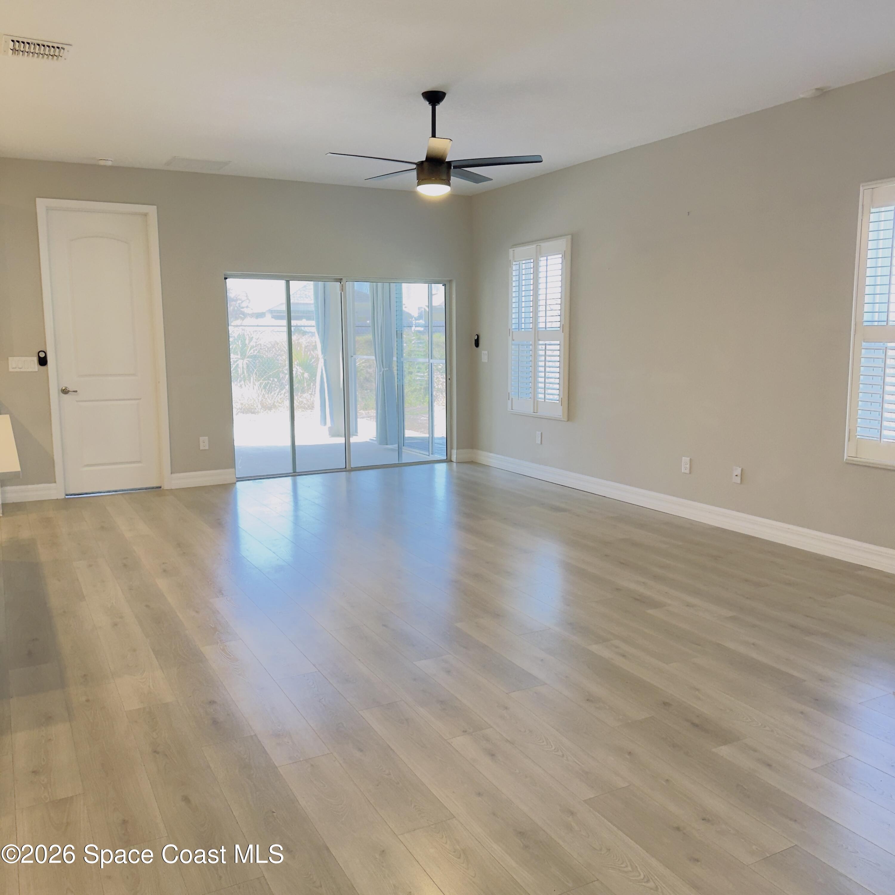 1376 Torgerson Road Southeast Palm Bay, FL 32909 - Photo 3 of 15 wooden floor in an empty room with a window