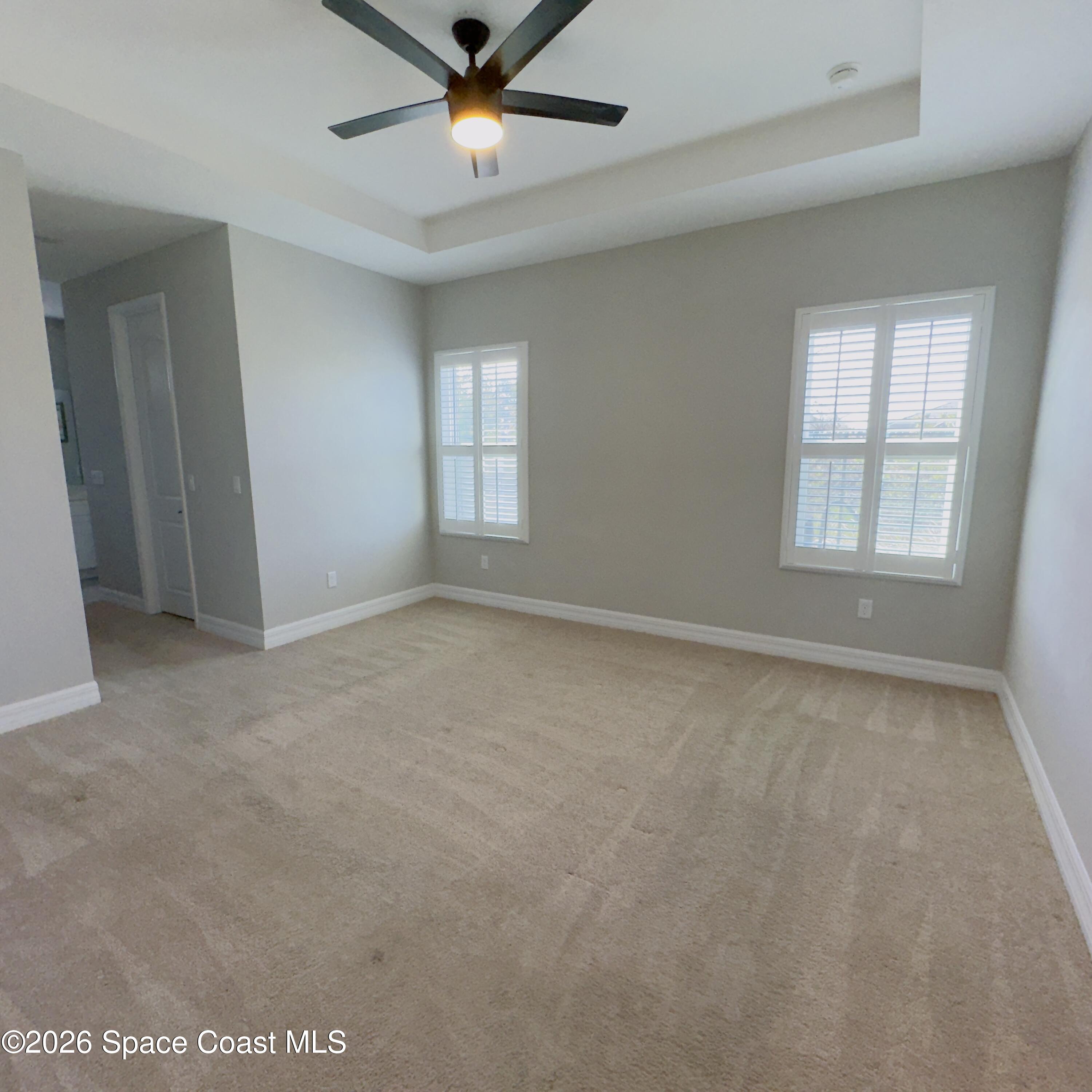 1376 Torgerson Road Southeast Palm Bay, FL 32909 - Photo 5 of 15 an empty room with windows and fan