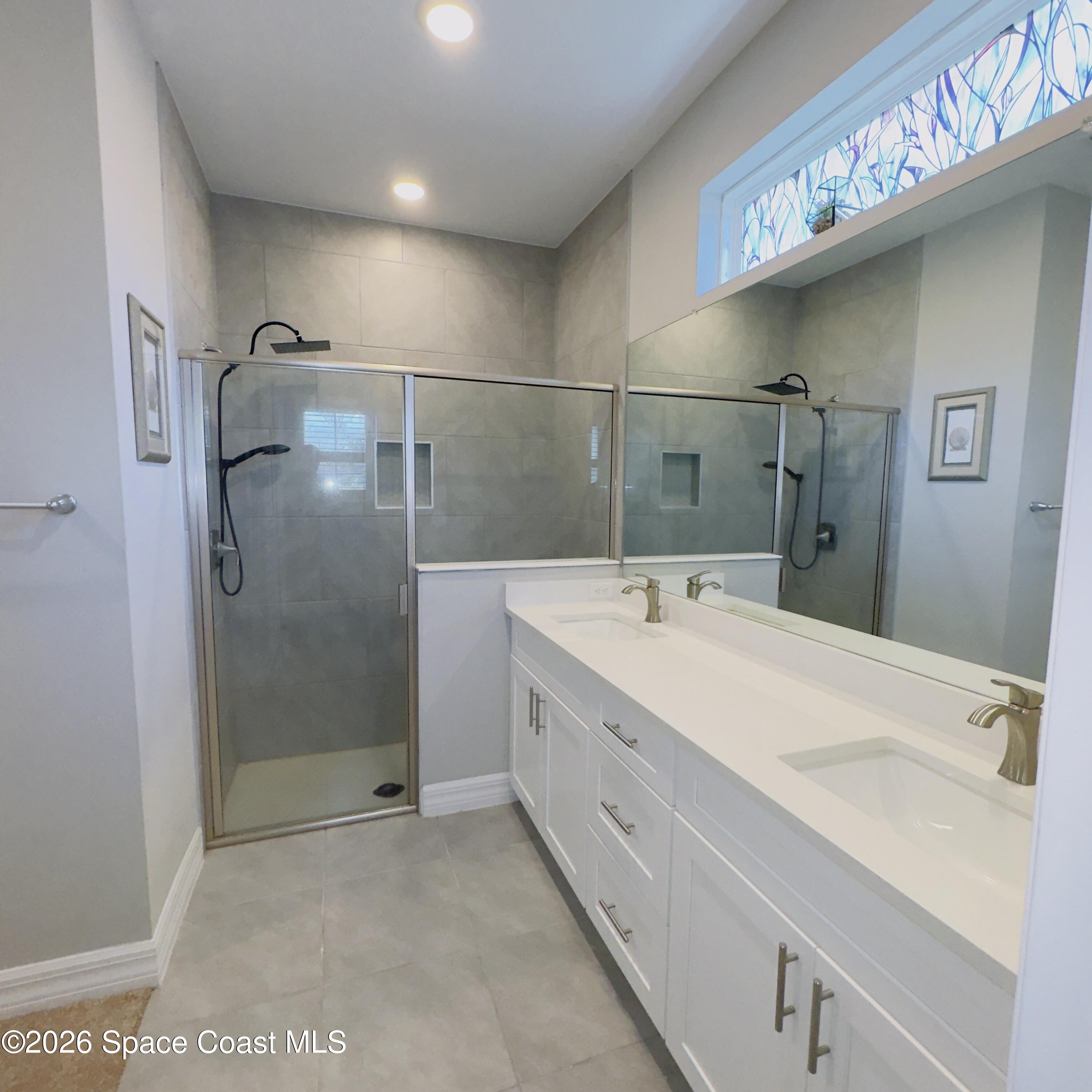1376 Torgerson Road Southeast Palm Bay, FL 32909 - Photo 6 of 15 a bathroom with a double vanity sink and mirror